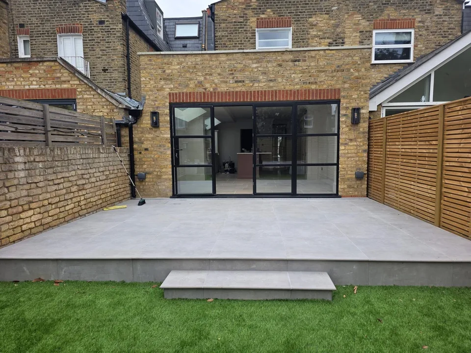 Completed rear extension with architectural glazing, terrace and landscaped garden