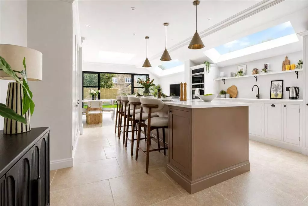 Furnished kitchen with an island, pendant lights and roof glazing