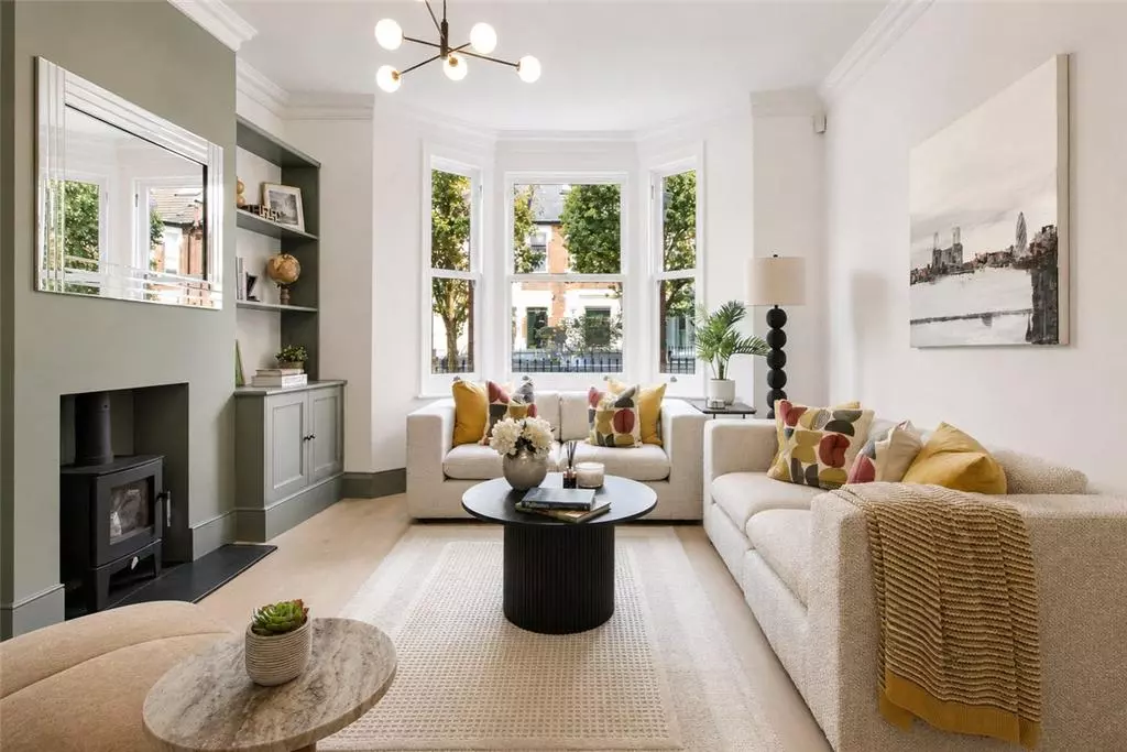 Furnished front reception with bay windows, a fireplace and fitted shelving