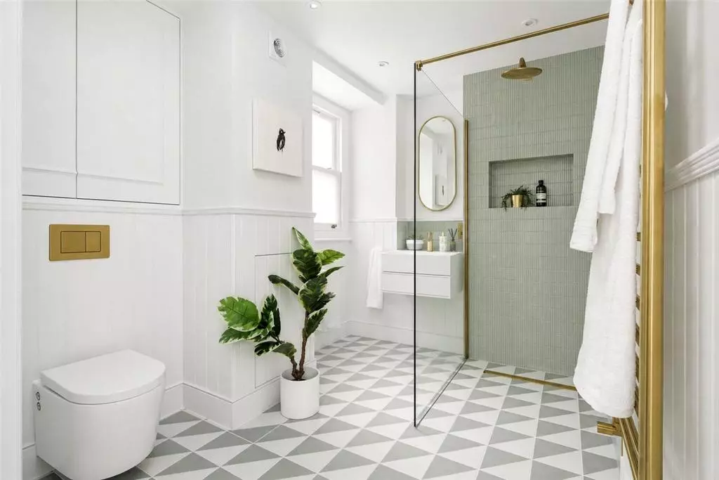 Bathroom with a glazed shower, fitted vanity and geometric tiled floor