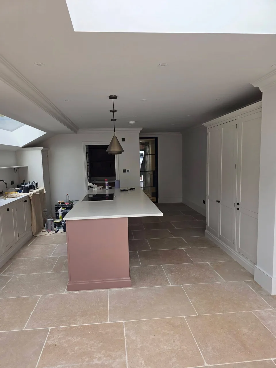 Finished kitchen with stone island and bespoke dark cabinetry