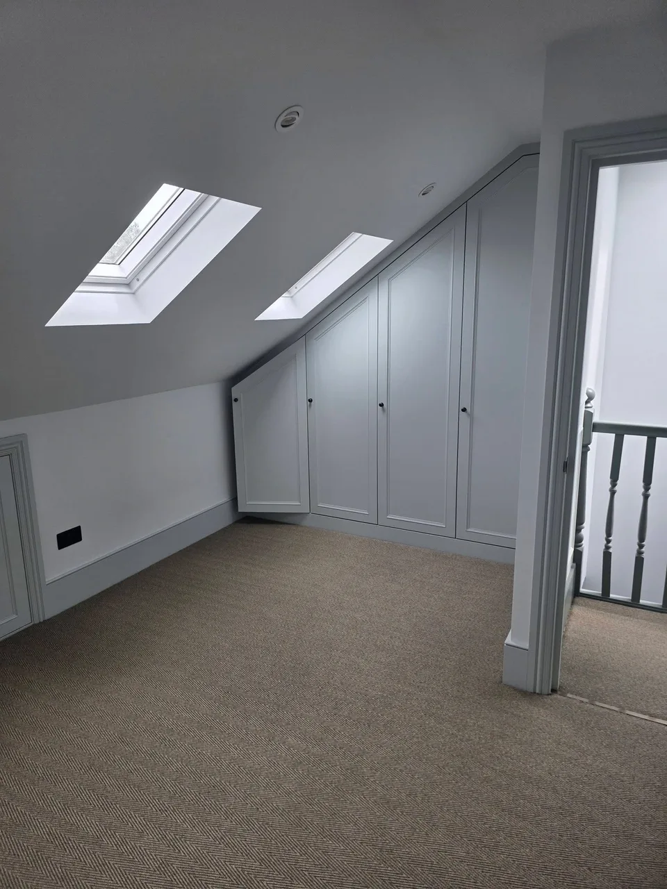 Completed bright loft room with rooflights and finished timber floor