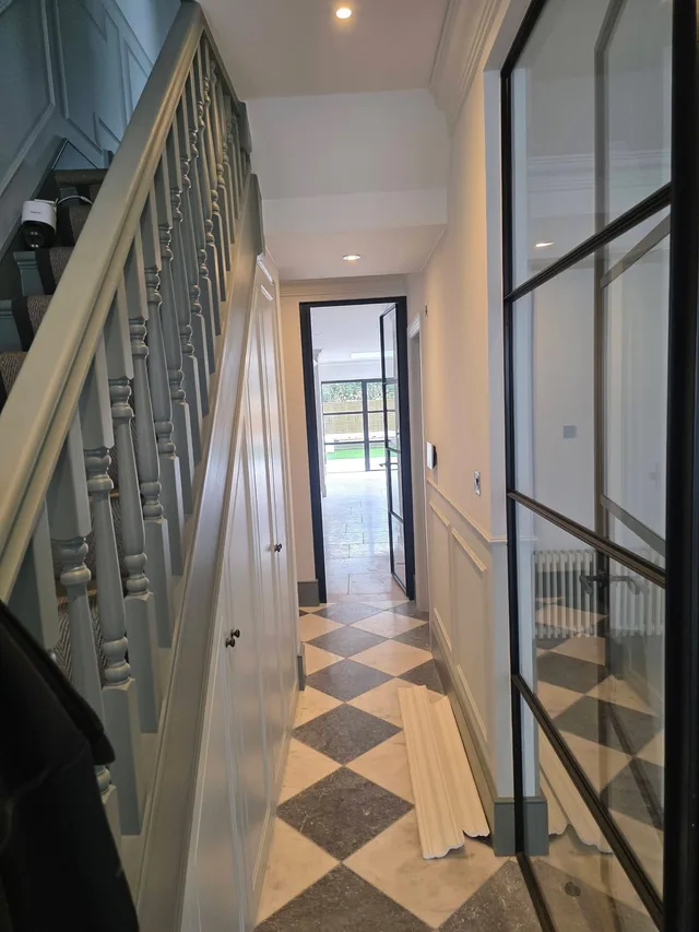 Finished staircase with architectural glazing and patterned floor